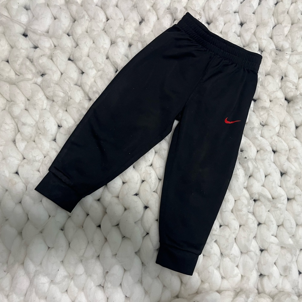 Nike Kids Black Joggers with Red Swoosh Accent